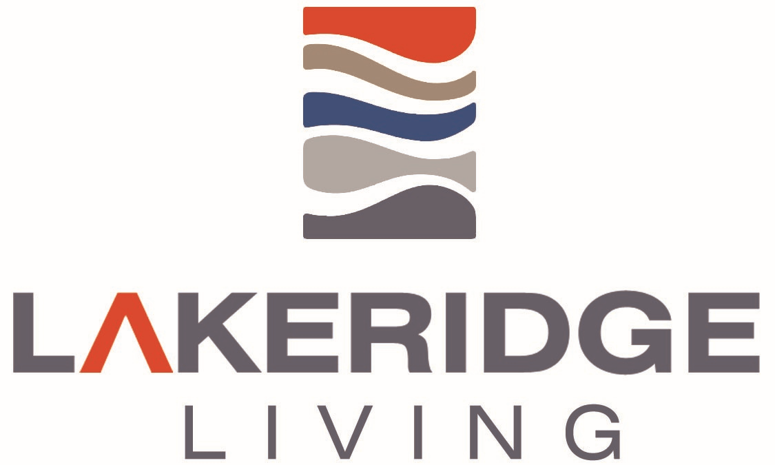 The image shows a logo with the text "LAKERIDGE LIVING" in front of a graphic of three horizontal stripes in red, white, and blue.